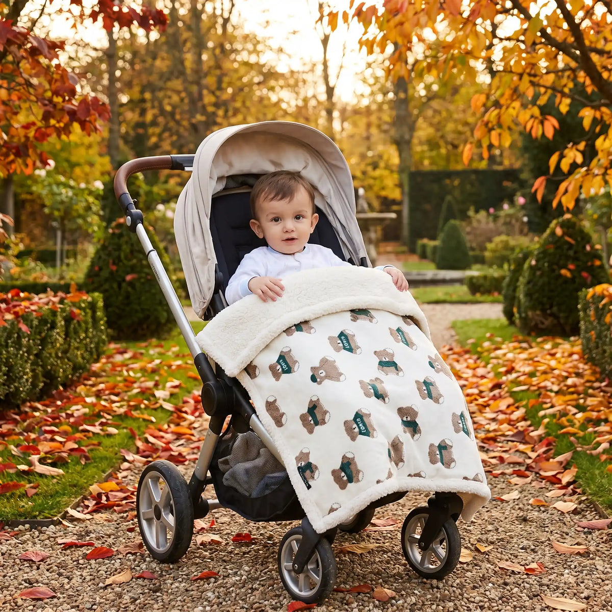 bébé en promenade au jardin au chaud dans sa couverture en polaire bebe motif ourson
